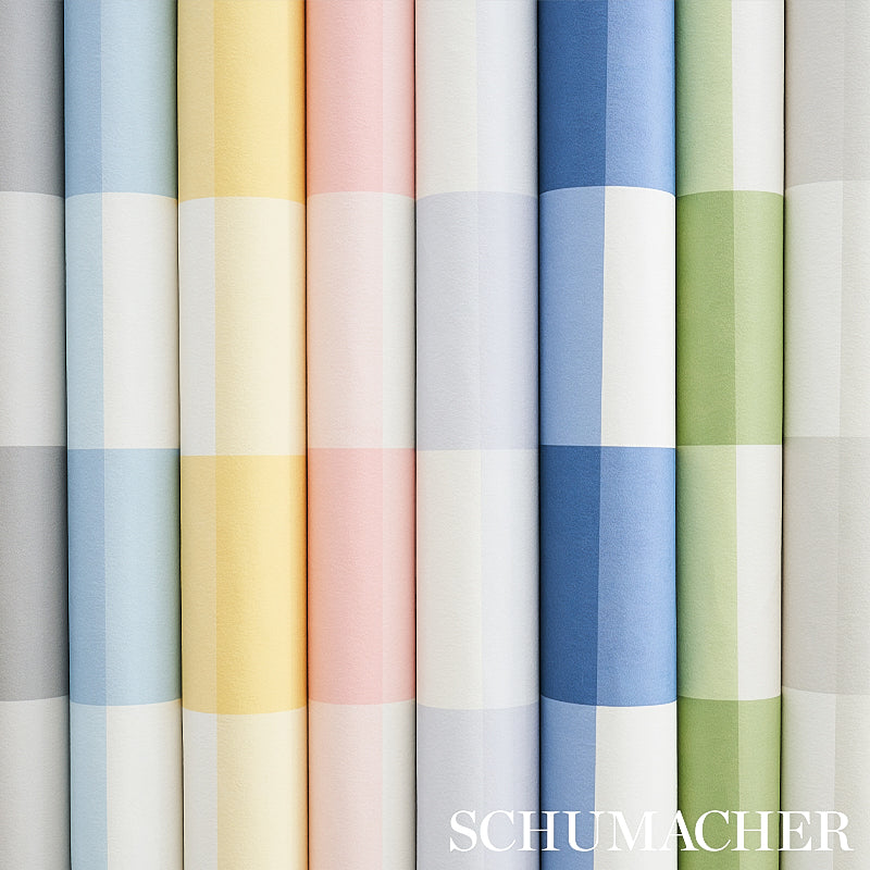 Rows of wallpaper rolls with a large plaid check in seaglass and pastel tones; blue, yellow, pink, gray and green; Schumacher watermark.