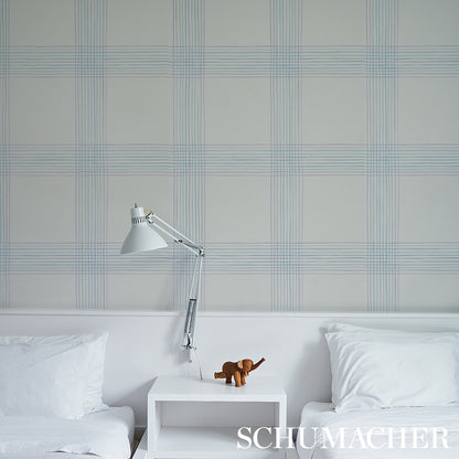 Minimalist white bedroom with twin beds, adjustable silver lamp on nightstand, brown plush elephant, blue plaid wallpaper.