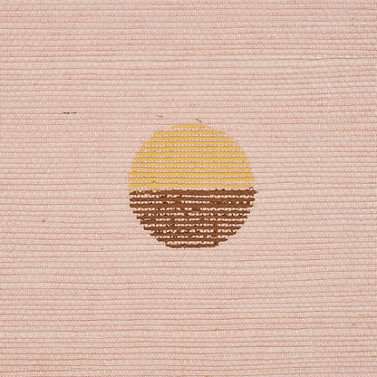 Peach hand printed sisal with a circular sun motif, yellow on the upper half and brown on the lower half.