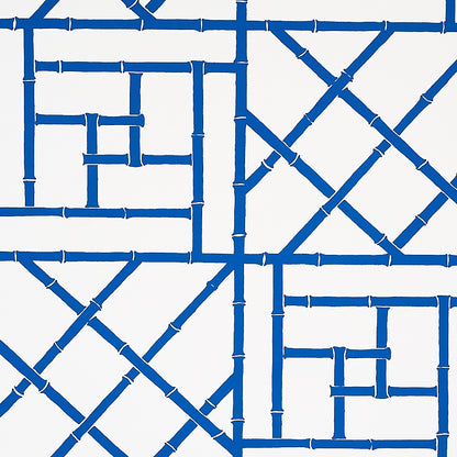 Indigo trellis wallpaper with an interlocking lattice pattern on a white background.