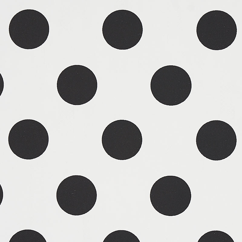 White fabric with evenly spaced black polka dots; classic bold polka dot pattern.