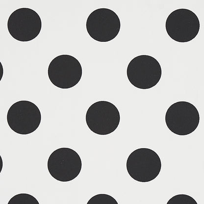 White fabric with evenly spaced black polka dots; classic bold polka dot pattern.
