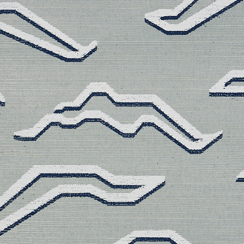 Light gray rug featuring white and navy blue geometric zigzag patterns.