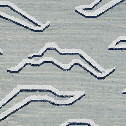 Light gray rug featuring white and navy blue geometric zigzag patterns.