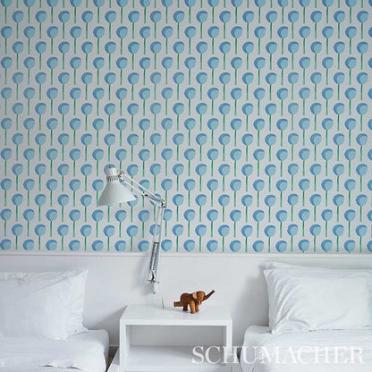 Bedroom with blue circular wallpaper, white bedding, chrome adjustable lamp, and a small wooden moose on a white nightstand.