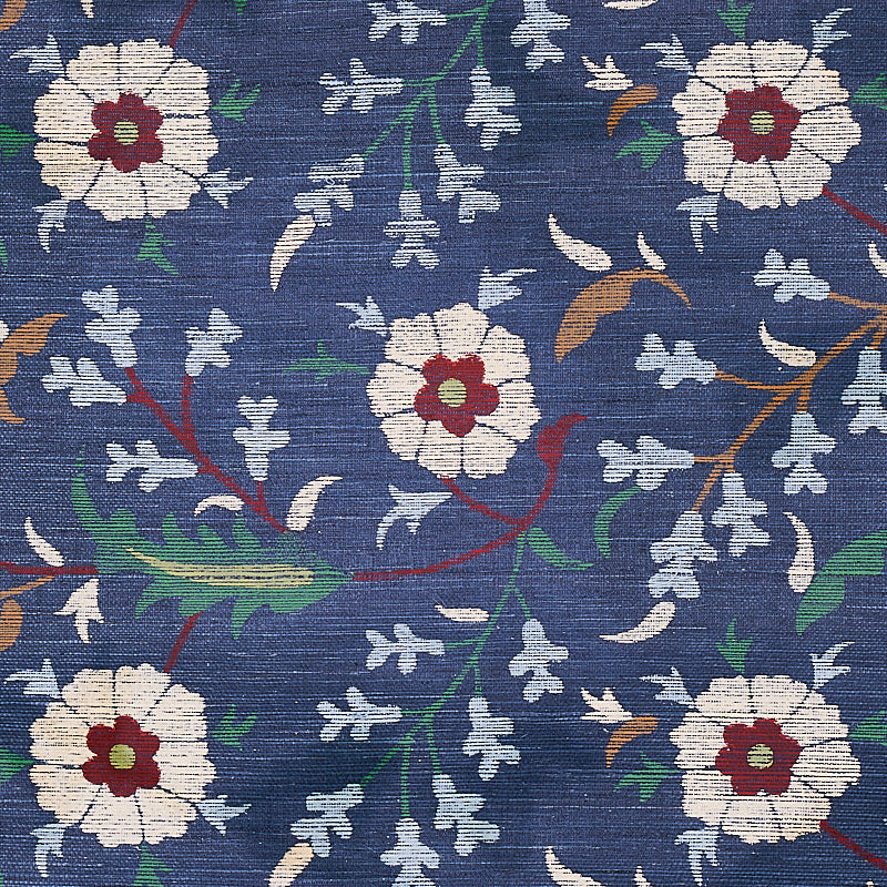 Blue sisal with a floral pattern of white flowers with red centers, green leaves and twisting vines.