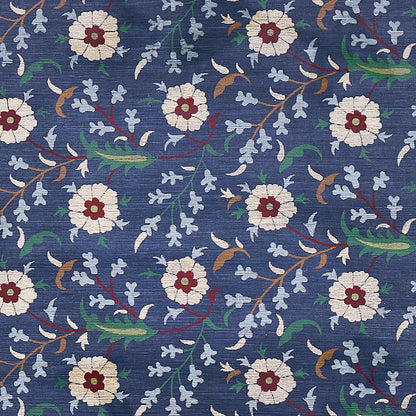 Navy blue floral print sisal rug with white blooms, burgundy centers, light blue accents, brown stems and green leaves.