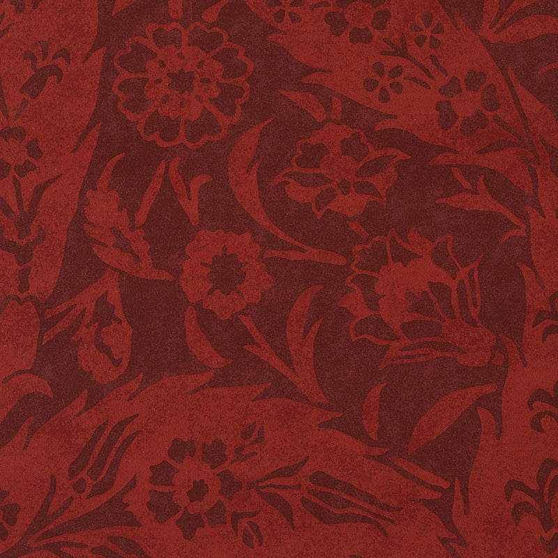 Red damask floral textile with ornate blossoms and swirling leaves.