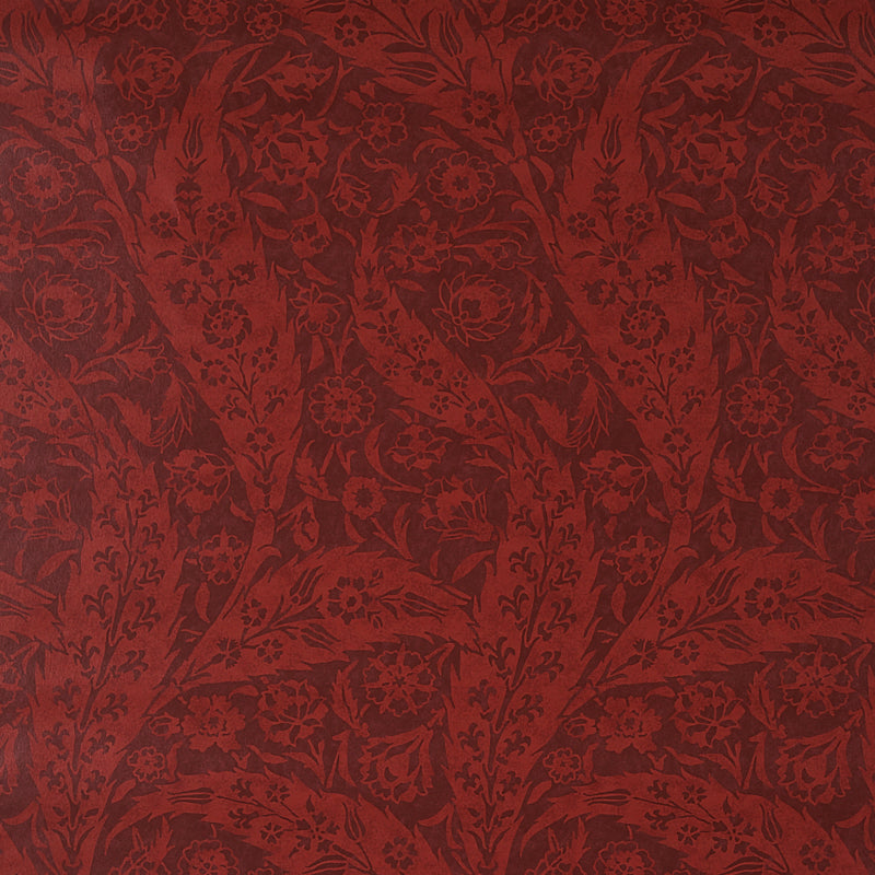 Deep burgundy paisley fabric with an ornate pattern, suitable for upholstery.