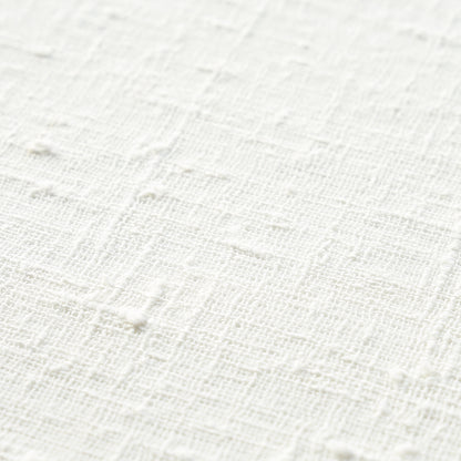 White textured fabric close-up with a subtle raised grid pattern; linen/cotton look.