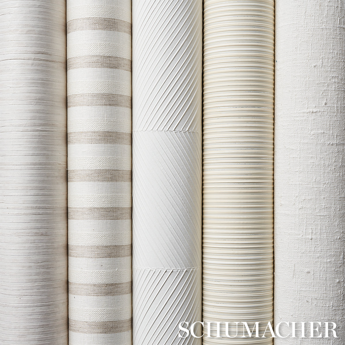 Row of neutral wallpaper rolls with striped and textured patterns in white, beige, ivory, and light gray.