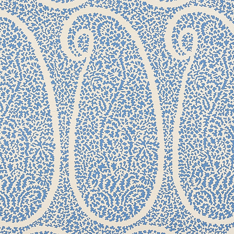 Blue-on-white damask-style pattern with ornate scrolls on grasscloth wallpaper.
