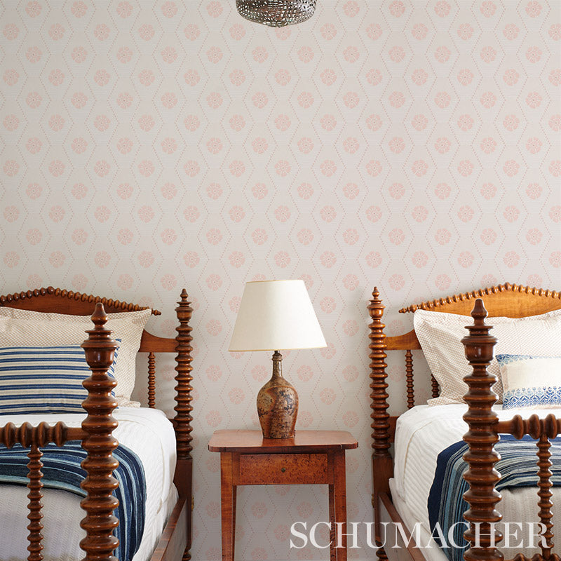 Twin carved wooden beds with blue striped bedding, ceramic lamp on a small nightstand between them, vintage bedroom set.