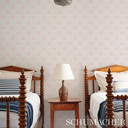 Twin carved wooden beds with blue striped bedding, ceramic lamp on a small nightstand between them, vintage bedroom set.