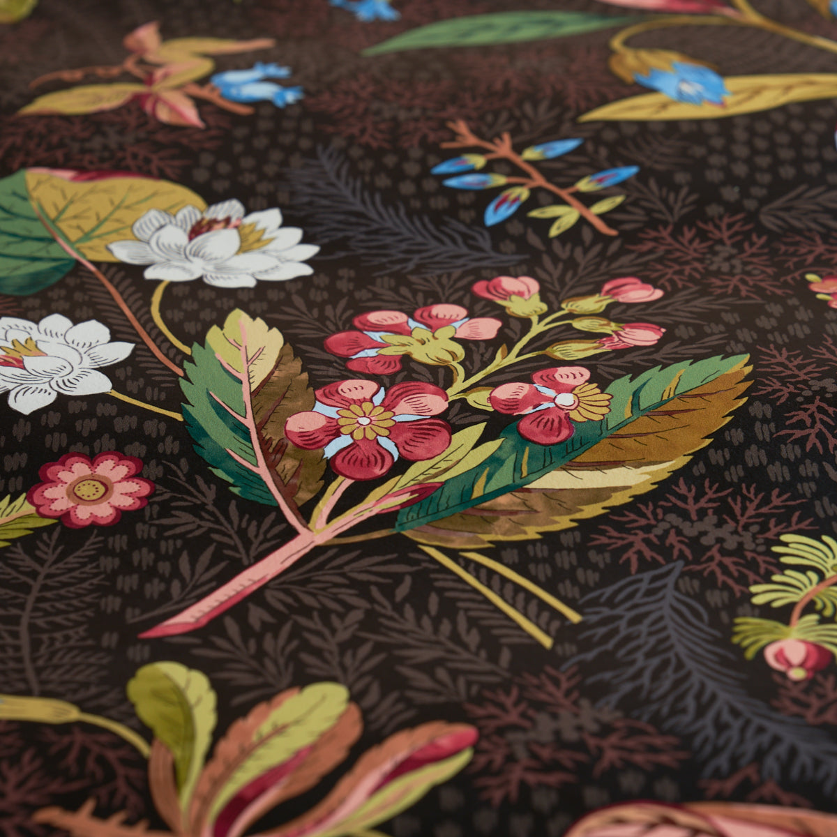 Black fabric with a vibrant floral print featuring pink, white, and yellow blossoms and green leaves.
