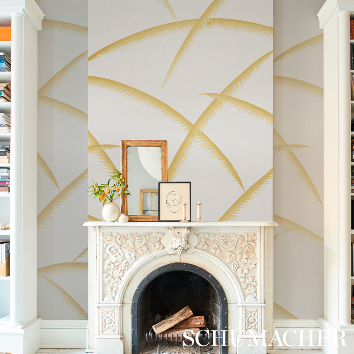 Gold palm-deco wallpaper with palm motifs; includes gold frame, small mirror, vase & candles.