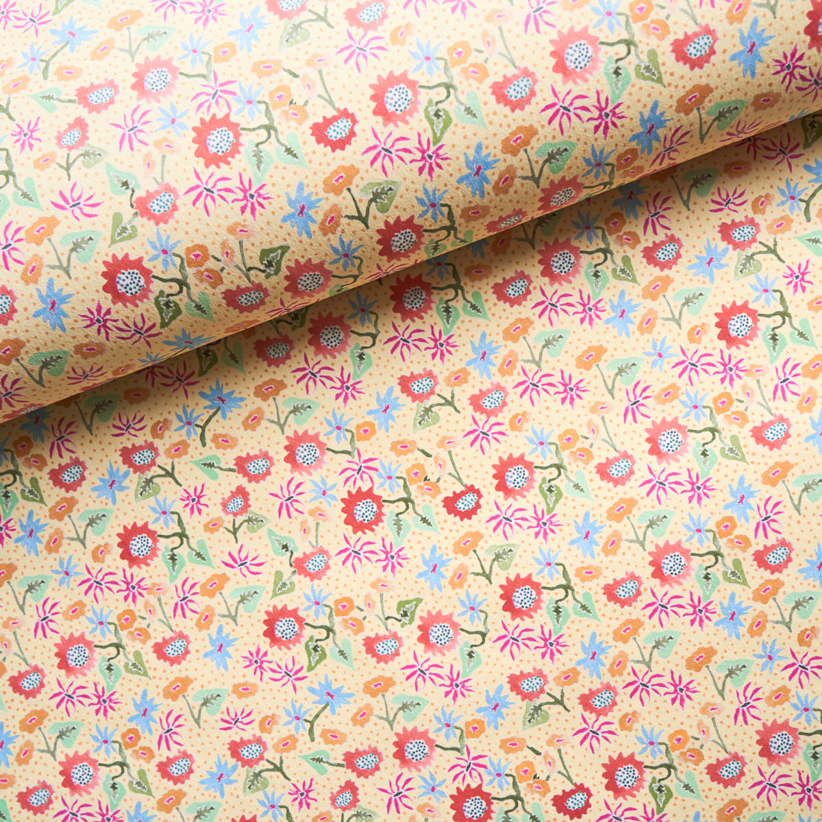 Beige calico fabric with a tiny multicolor floral print (pink, red, blue, green) and vines; rolled at top.