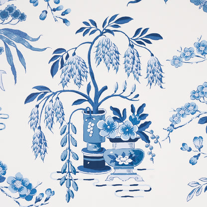 Blue and white porcelain floral pattern featuring a central vase, cascading wisteria and blooming branches.