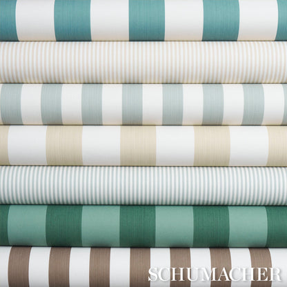 Stacked fabric bolts showing a dark green striped fabric with alternating wide and narrow stripes.