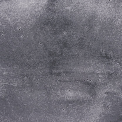 Off-black textured backdrop with subtle mottling and small pockmarks.