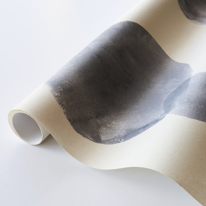 Rolled cream poster featuring a bold black abstract brushstroke, parchment-like finish, modern wall art.