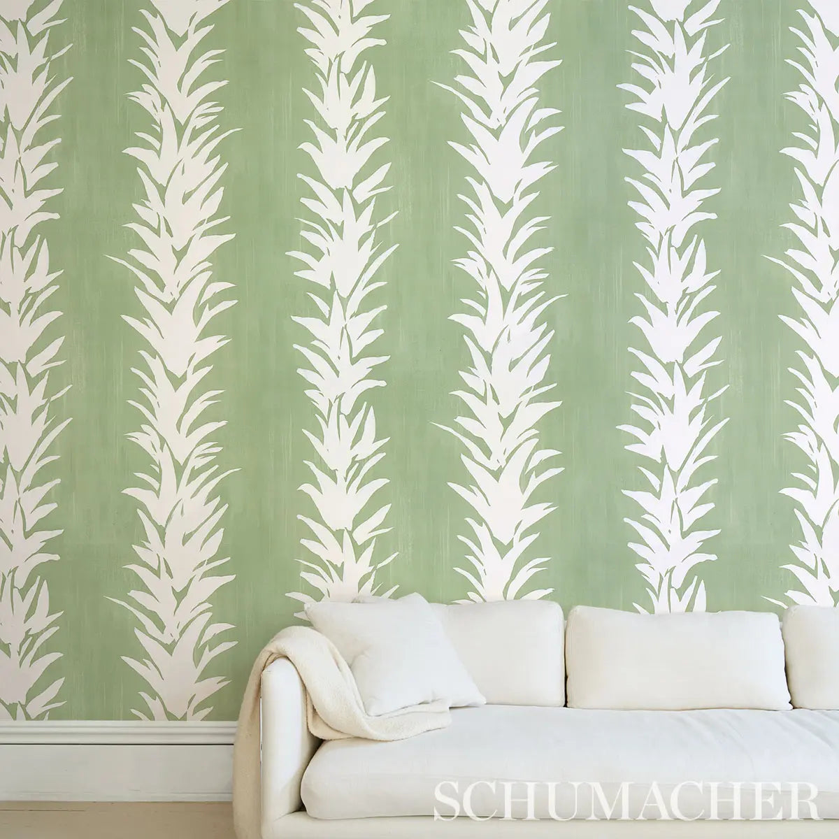 Schumacher White Lotus Wallpaper in soft green, delicate lotus floral motifs, luxury designer wallcovering for bedrooms, living rooms, and dining areas, botanical wallpaper for modern, classic, and minimalist interiors
