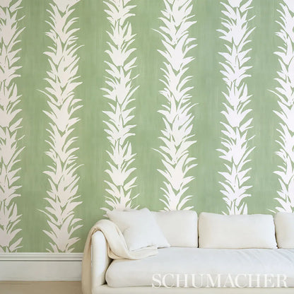 Schumacher White Lotus Wallpaper in soft green, delicate lotus floral motifs, luxury designer wallcovering for bedrooms, living rooms, and dining areas, botanical wallpaper for modern, classic, and minimalist interiors