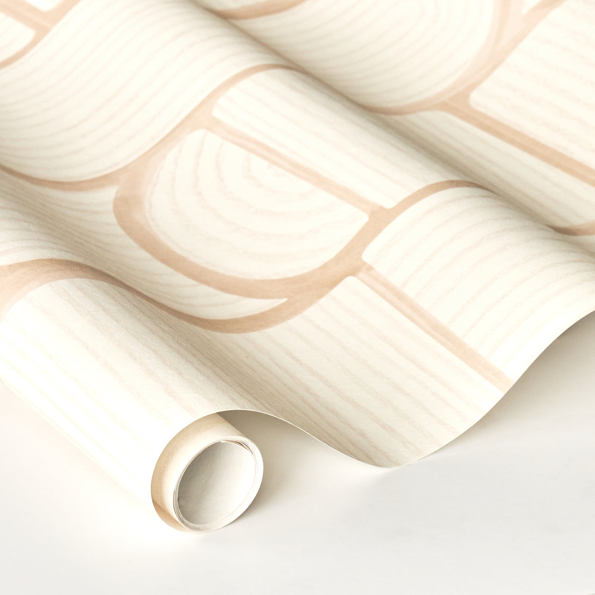 Cream wallpaper with pale peach brick pattern, rolled edge and soft folds