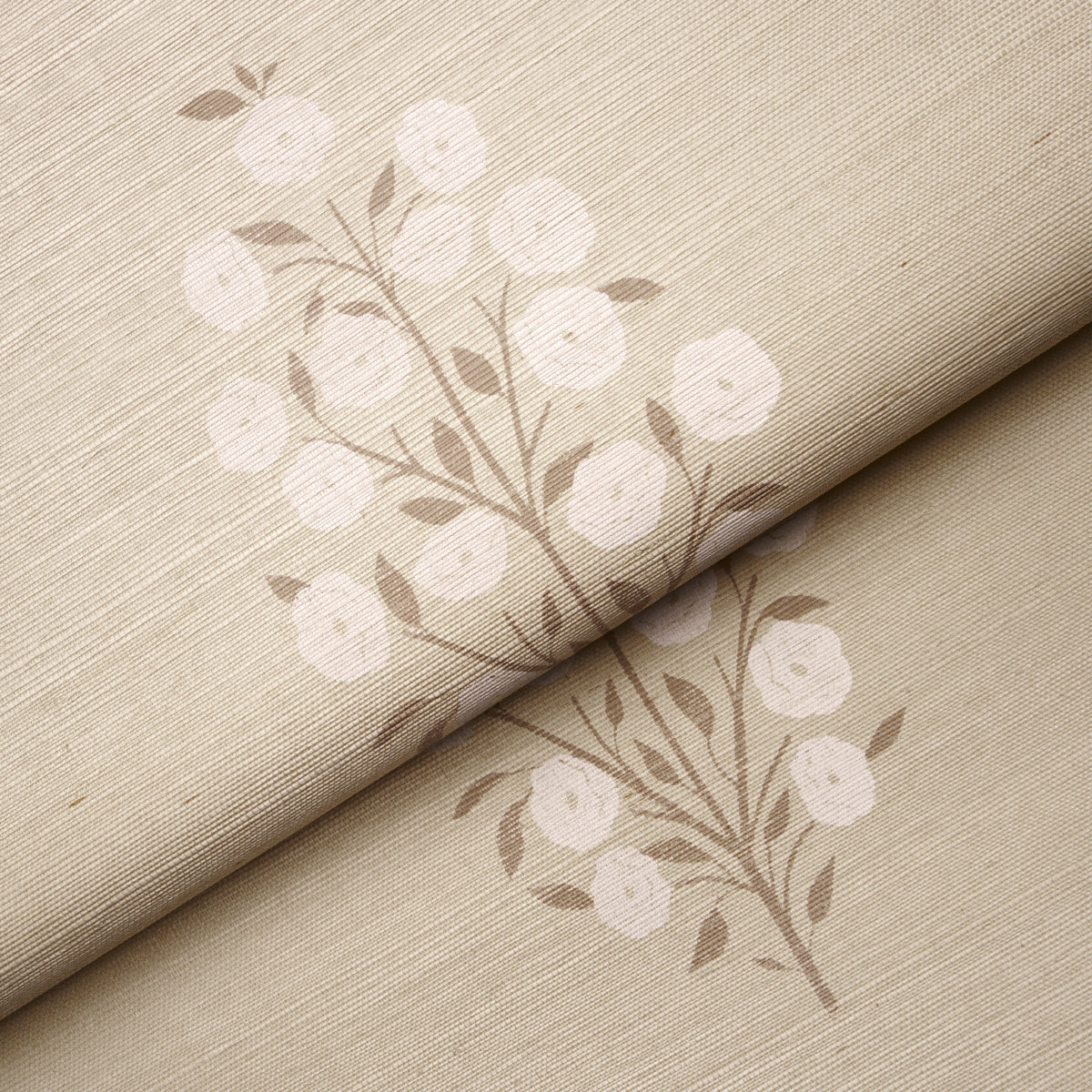 Beige linen-like fabric with white botanical blossoms on brown stems; rolled fabric sample with subtle floral pattern.