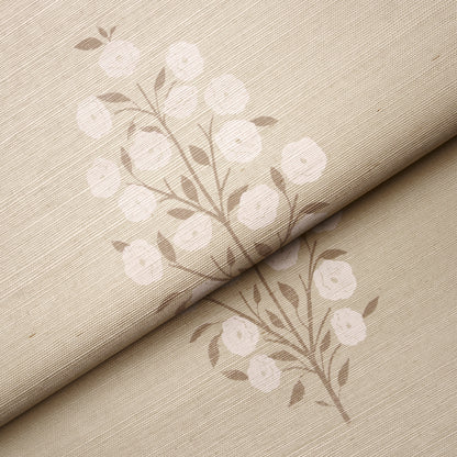 Beige linen-like fabric with white botanical blossoms on brown stems; rolled fabric sample with subtle floral pattern.