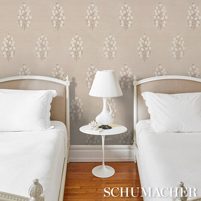 Twin bedroom with white bedding, beige upholstered headboards, round white nightstand, white lamp, floral wallpaper.