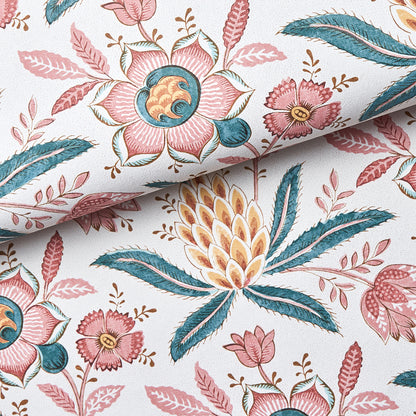 Floral fabric in pink, teal, and yellow with leaves on white; botanical pattern, cotton-like material.