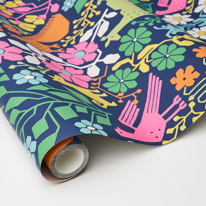 Rolled wallpaper with a vivid tropical floral pattern on a navy background; pink, green, orange flowers and leaves.