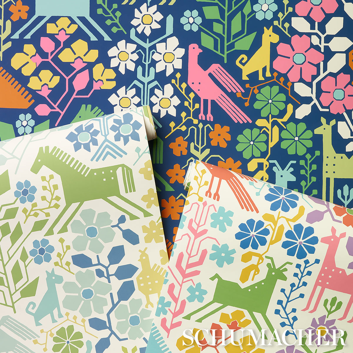 Bold folk-art floral and animal print on navy; pink, green, blue foliage with stylized horses and birds; layered fabric swatches.