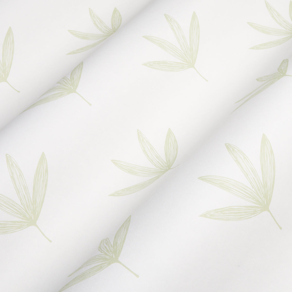 Rue Green fabric with pale sage palm-leaf pattern, soft drape and subtle diagonal folds