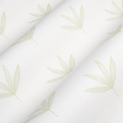 Rue Green fabric with pale sage palm-leaf pattern, soft drape and subtle diagonal folds