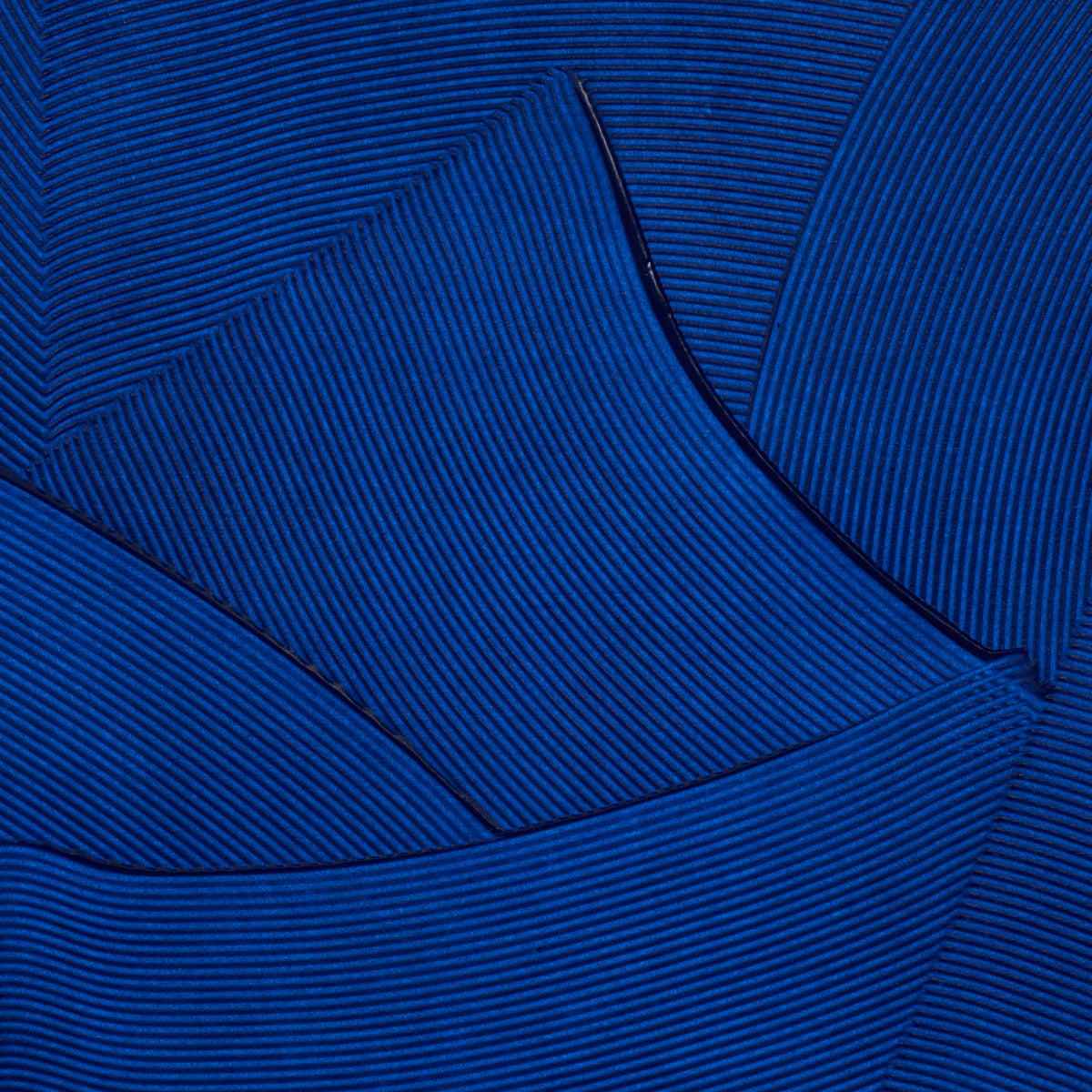 Royal blue wallpaper with a plaster-like texture and visible seams.