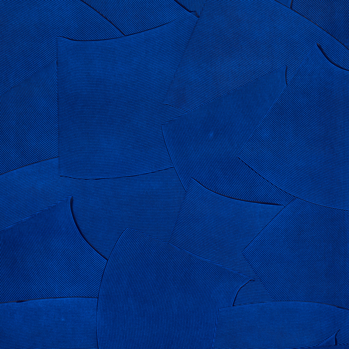 Overlapping cobalt-blue fabric swatches with fine ribbed texture in an abstract collage.