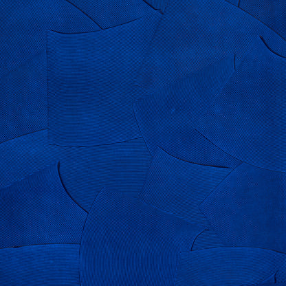 Overlapping cobalt-blue fabric swatches with fine ribbed texture in an abstract collage.