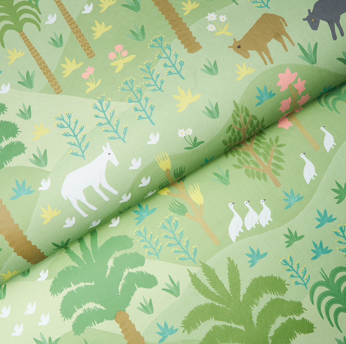 Green fabric with jungle print: palm trees, ferns, and pastel animals.