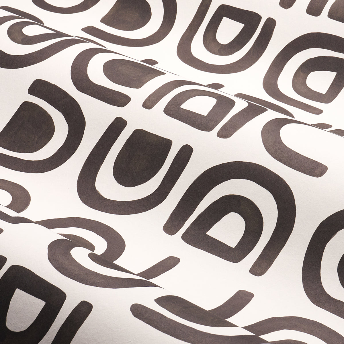 Charcoal textile with repeating dark brown rounded-square loop shapes; retro geometric pattern for upholstery or decor.