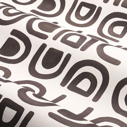 Charcoal textile with repeating dark brown rounded-square loop shapes; retro geometric pattern for upholstery or decor.