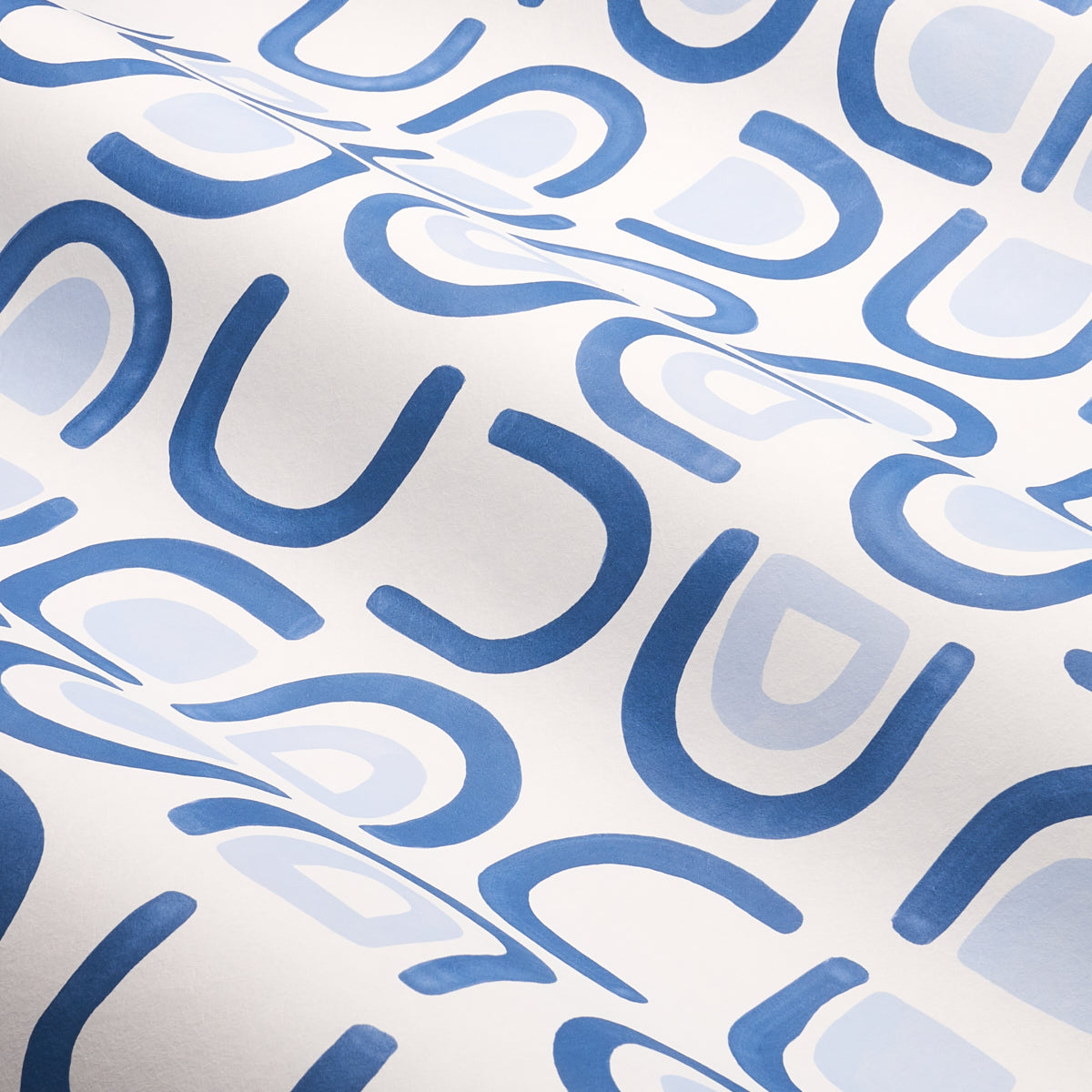 White fabric with repeating blue curved U-shapes and light blue ovals; abstract modern textile print.