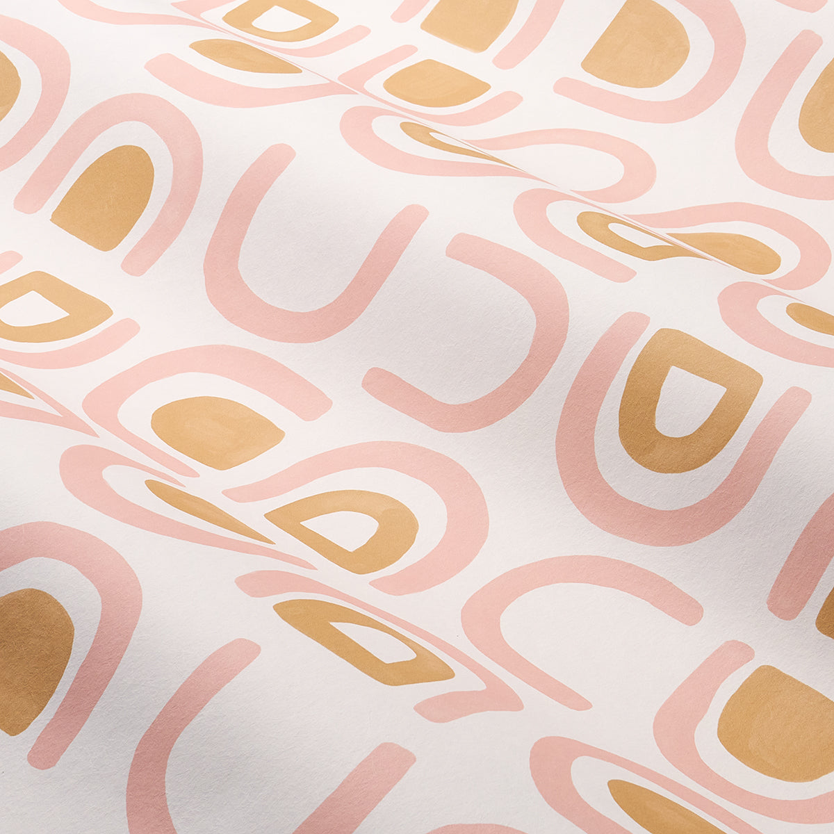 Soft white fabric with abstract pink and peach curved shapes and mustard yellow geometric accents, modern retro print.