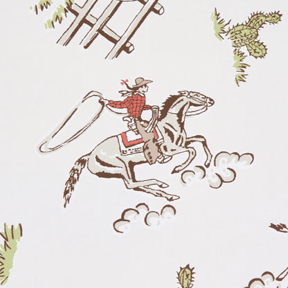 Wild West cream wallpaper: whimsical scene of a cowboy in a red plaid shirt riding a rearing grey horse, dust puffs, cacti and a rustic fence.