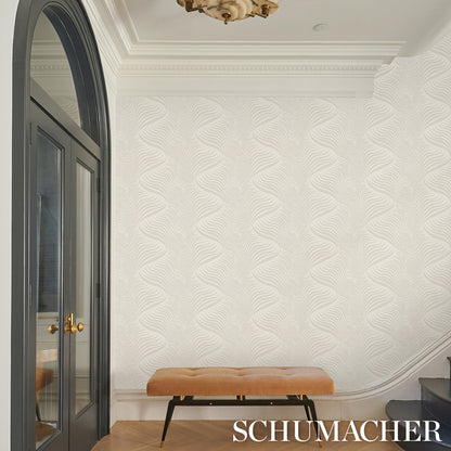 Light, wavy wallpaper in neutral dove tones, shown in an elegant room with an arched black door.