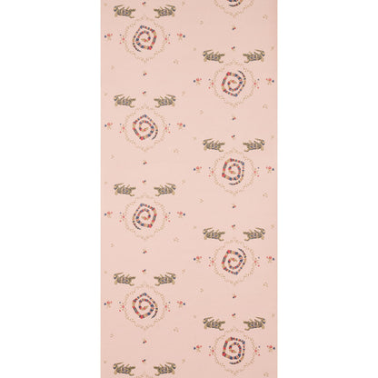 Soft muted pink backdrop fabric with reptile-themed pattern.