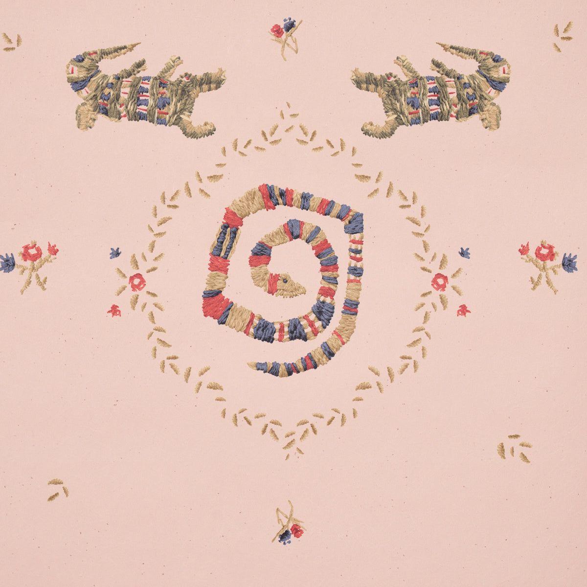 Pastel pink fabric with multicolor yarn embroidery forming a centered spiral, gold leafy border motifs and small florals in folk-art style.