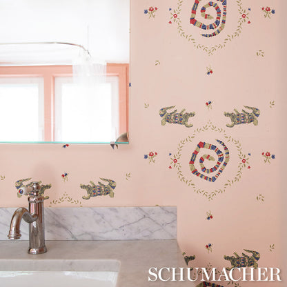 Pink muted wallpaper with a turtle motif and circular color wreaths.