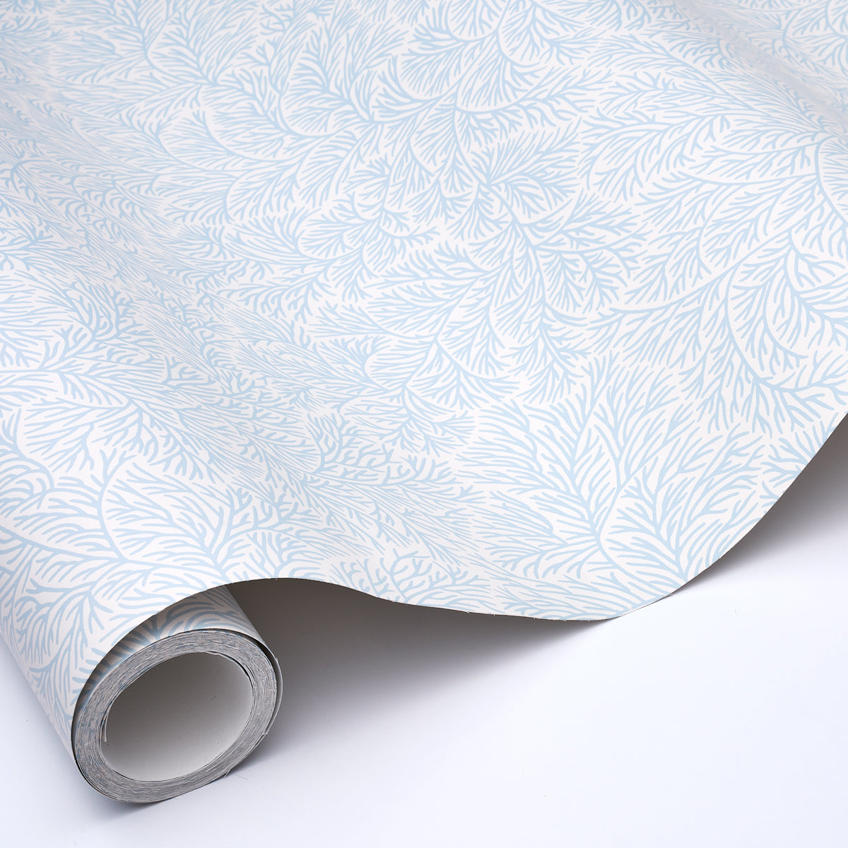 Roll of light blue botanical leaf wallpaper with a delicate pattern on white background